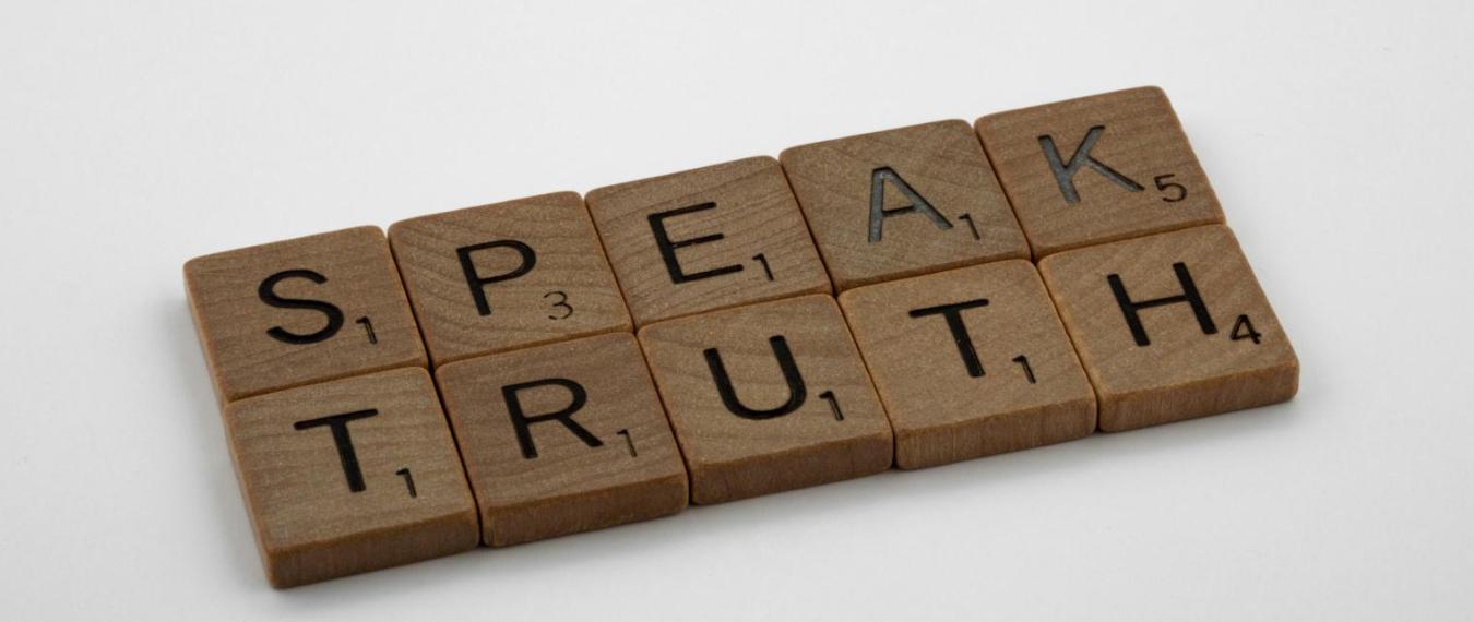 Scrabble tiles that spell out "speak truth"