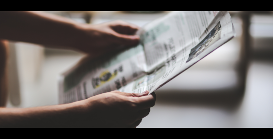 Picture of person holding a newspaper