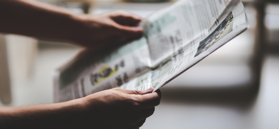 Picture of person holding a newspaper