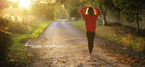 Woman walking along country lane