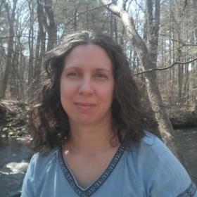 woman with medium length brown hair wearing blue shirt