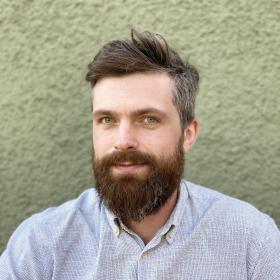 man with a beard looking at the camera