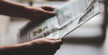 Picture of person holding a newspaper