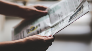 Picture of person holding a newspaper
