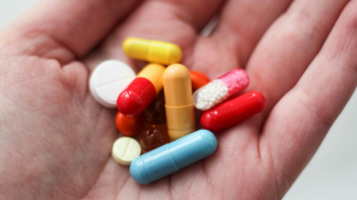 Hand holding pills: Photo by Ksenia Yakovleva on Unsplash